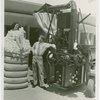 Hall of Invention - Man standing next to nude woman in cotton bale