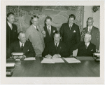 Hall of Pharmacy - Grover Whalen signing contracts with officials