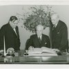 Hull, Cordell (Secretary of State) - Signing guestbook with Fiorello LaGuardia and Harvey Gibson