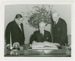 Hull, Cordell (Secretary of State) - Signing guestbook with Fiorello LaGuardia and Harvey Gibson