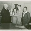 Harvey Gibson presenting model of Trylon and Perisphere to three blind children