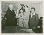 Harvey Gibson presenting model of Trylon and Perisphere to three blind children