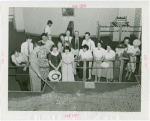 Illinois Participation - Group of men and women look at model of Chicago