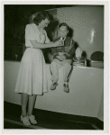 Illinois Participation - Woman giving Eugene Doyle milk