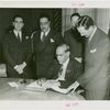 India Participation - Maharaja of Kapurthala signing guestbook with officials
