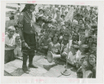 Indian (Native American) Participation - Hopi chief on stage surrounded by children