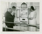 Infant Incubator - Martin and Hildegarde Couney with boy looking at baby in incubator