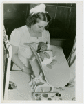 Infant Incubator - Nurse weighing baby