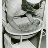 Infant Incubator - Nurse giving baby a bath