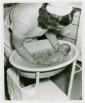 Infant Incubator - Nurse giving baby a bath