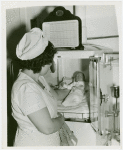 Infant Incubator - Nurse putting baby into incubator