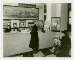 Information Booths - Attentant showing man map at Touring Bureau