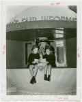 Information Booths - Attendant giving two girls directions in booth shaped like Perisphere