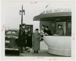 Information Booths - Attendent with family at booth shaped like Perisphere