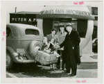 Information Booths - Attendent giving family information in front of booth shaped like Perisphere