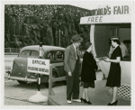 Information Booths - Attendant giving information to first out-of-town visitors at booth shaped like Perisphere outside of Holland Tunnel