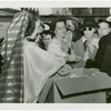 Iraq Participation - Woman in traditional dress giving away dates