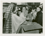 Iraq Participation - Woman in traditional dress giving away dates
