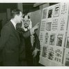 Iraq Participation - Man displays stamps