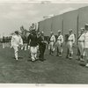 Ireland Participation - Robert Brennan and group walk in front of military