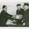 Jewels - Man gives box to officials
