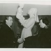 Jewish-Palestine Participation - Man and woman shake hands in front of statue
