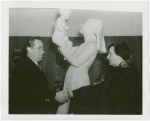 Jewish-Palestine Participation - Man and woman shake hands in front of statue