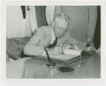 Governor of Louisiana signs book (close-up)