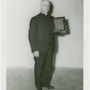 Reverend John H. Lamott holding plaque