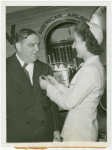LaGuardia, Fiorello, H. - Decoration Ceremonies - American Airlines hostess pinning on emblem