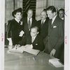 Lebanon Participation - Charles Corm (Commissioner General) signs book with group looking on