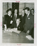 Lebanon Participation - Charles Corm (Commissioner General) signs book with group looking on