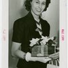 Madge Magnus (Miss Jamaica) holding gift