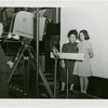 Machinery - Woman and girl in front of camera