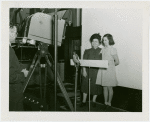 Machinery - Woman and girl in front of camera