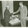 Man Building - Walter Hoving (Lord and Taylor) and John Starbuck shake hands in front of model