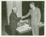 Man Building - Walter Hoving (Lord and Taylor) and John Starbuck shake hands in front of model