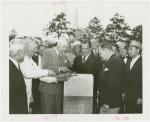 Man Building - Grover Whalen and group laying cornerstone
