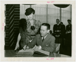 Maryland Day - Herbert O'Connor (Governor) signing guestbook while his wife look on