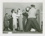 Medicine and Public Health - Men playing tug of war with rope looped around Shyam Sundar Goswami's neck