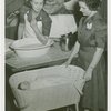 Medicine and Public Health - Nurses demonstrating correct way to bathe baby