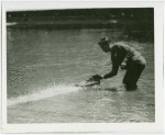 Michigan Participation - Man with model boat in water