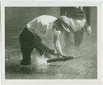 Michigan Participation - Man with model boat in water
