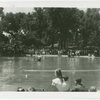 Michigan Participation - Crowd around lake watching man and model boat in water