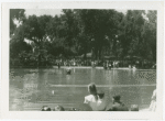 Michigan Participation - Crowd around lake watching man and model boat in water