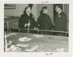 Michigan Participation - Grover Whalen with two officials behind model of Fair