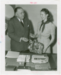 Michigan Participation - Peach Queen presenting official with basket of peaches