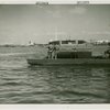 Mosquito protection and control - Men in boat spraying insecticide into water