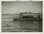 Mosquito protection and control - Men in boat spraying insecticide into water