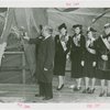 New England Participation - Man christening S.S. Yankee with champagne while beauty queens watch